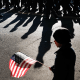 A child holds an American Flag as the Veterans Day Parade passes.